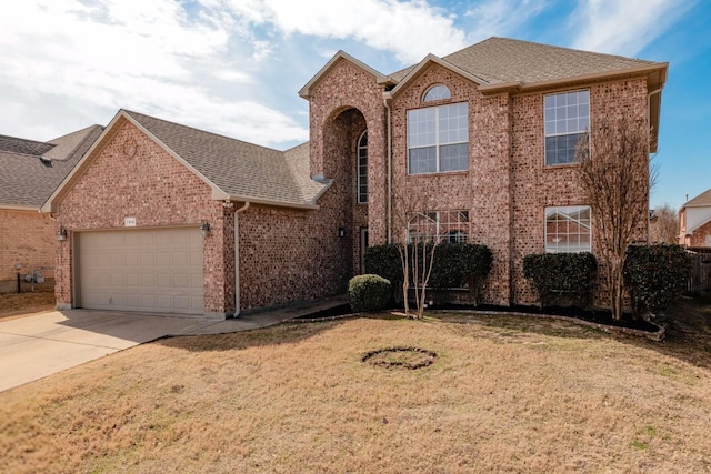 traditional home featuring a front lawn, brick siding, driveway, and an attached garage