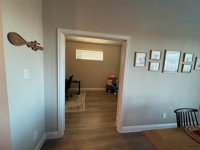 hallway with dark hardwood / wood-style floors