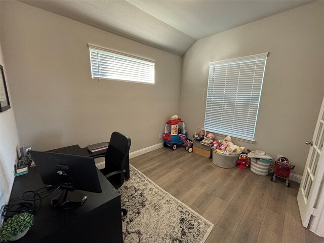 office area featuring vaulted ceiling and hardwood / wood-style flooring