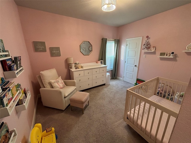 carpeted bedroom featuring a crib