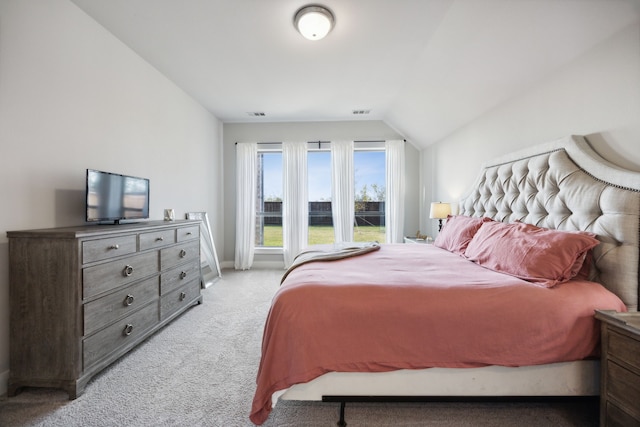 carpeted bedroom with lofted ceiling