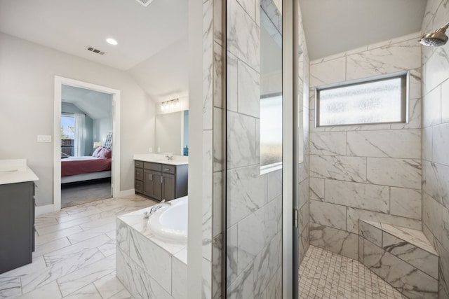 bathroom with plenty of natural light, separate shower and tub, lofted ceiling, and vanity