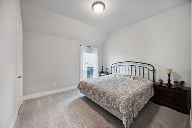 carpeted bedroom with vaulted ceiling