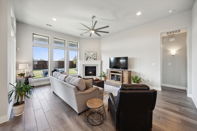 living room with ceiling fan and dark hardwood / wood-style floors