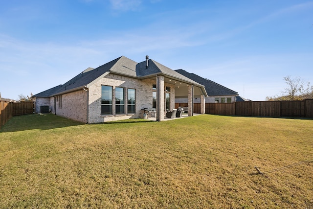 back of house with a patio area, a yard, and cooling unit