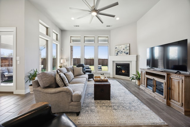 living room with ceiling fan and dark wood-type flooring