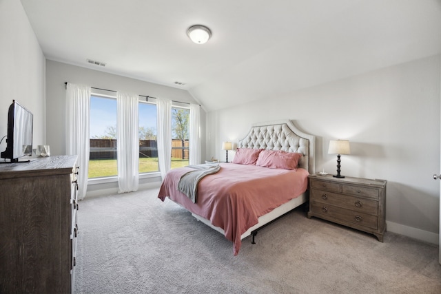 carpeted bedroom with lofted ceiling