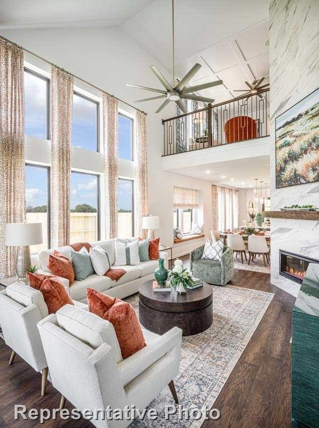 living room with a fireplace, dark hardwood / wood-style flooring, high vaulted ceiling, and ceiling fan