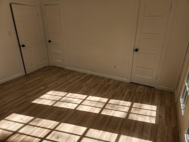 empty room with wood-type flooring