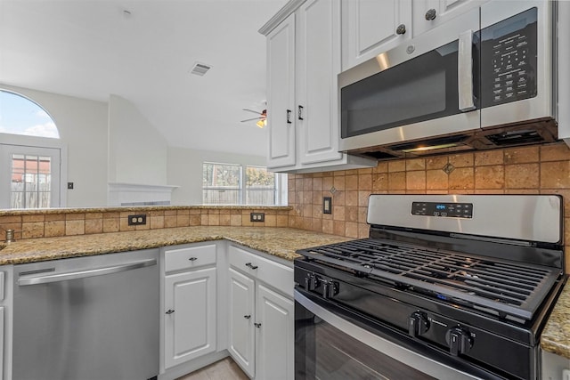 kitchen featuring light stone countertops, white cabinets, and appliances with stainless steel finishes