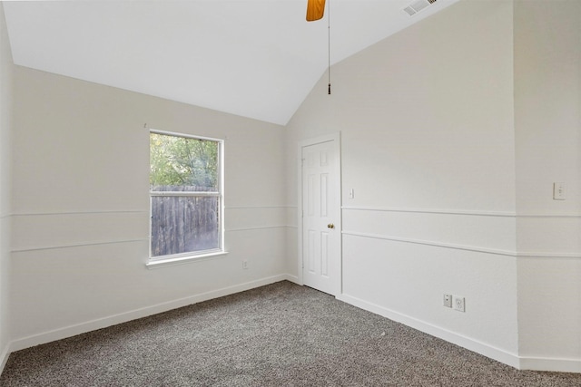 carpeted empty room featuring vaulted ceiling and ceiling fan