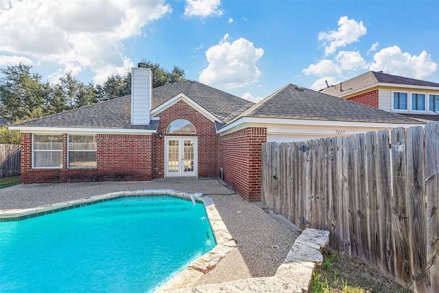 view of swimming pool featuring french doors