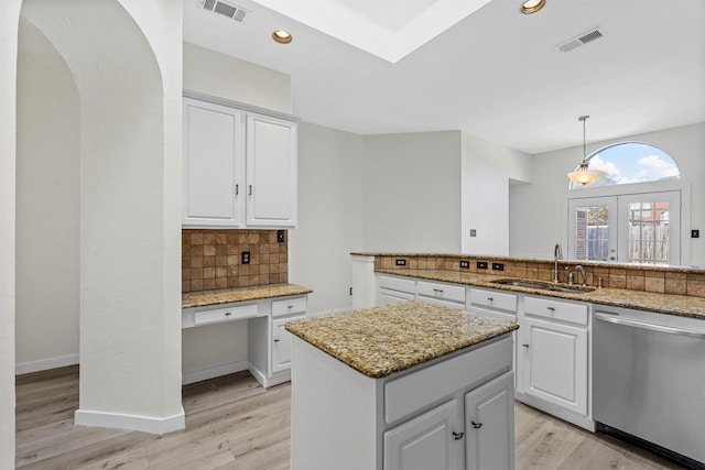 kitchen featuring pendant lighting, white cabinetry, sink, a center island, and stainless steel dishwasher