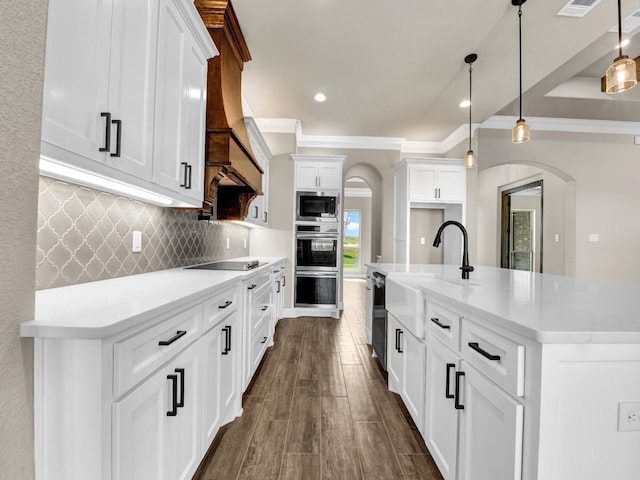 kitchen featuring dark hardwood / wood-style flooring, decorative light fixtures, white cabinetry, and stainless steel appliances