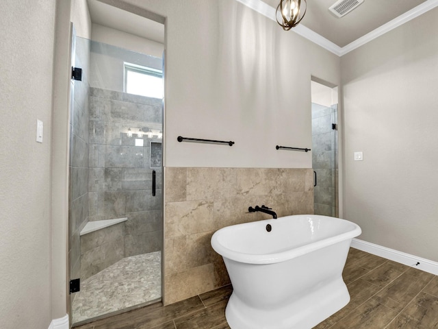 bathroom with wood-type flooring, separate shower and tub, and crown molding