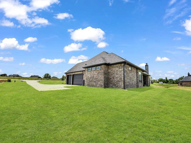 view of side of home with a lawn and a garage