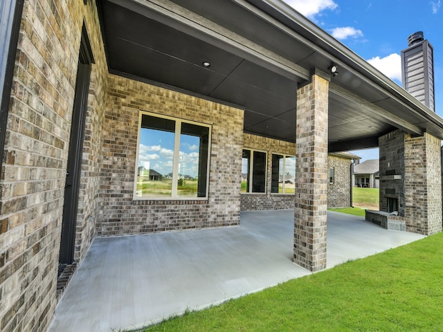 view of patio with an outdoor stone fireplace