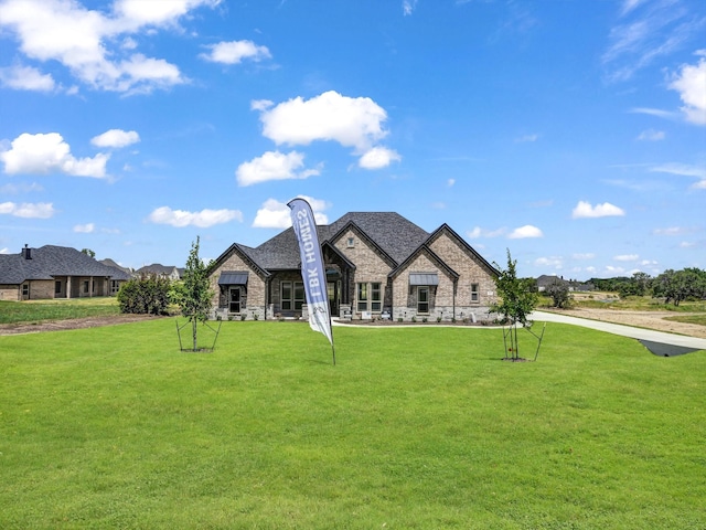 french country home with a front lawn