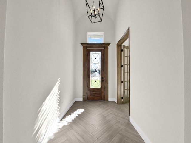 entrance foyer featuring light parquet flooring and an inviting chandelier