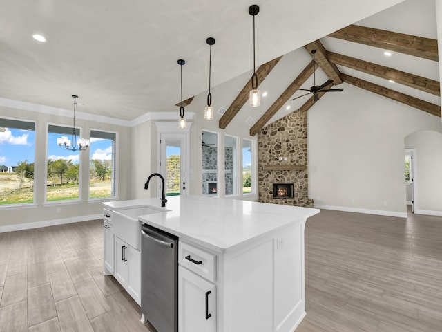 kitchen with vaulted ceiling with beams, dishwasher, an island with sink, and light hardwood / wood-style floors