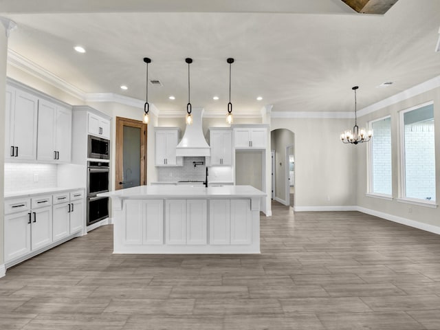 kitchen featuring white cabinets and decorative light fixtures