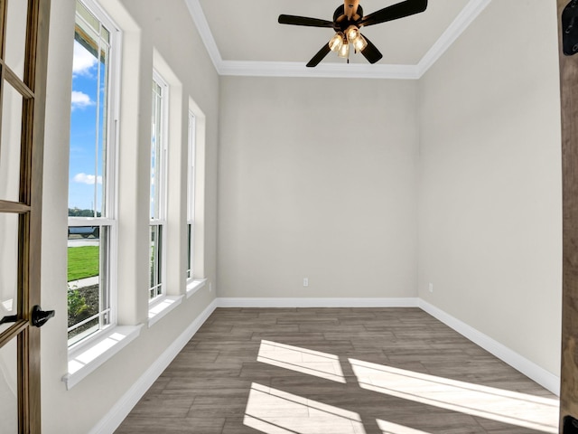 unfurnished room with hardwood / wood-style floors, ceiling fan, and crown molding