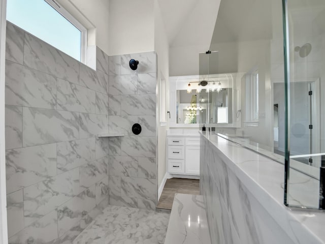 bathroom featuring vanity and tiled shower