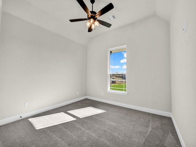 empty room with dark colored carpet, ceiling fan, and lofted ceiling