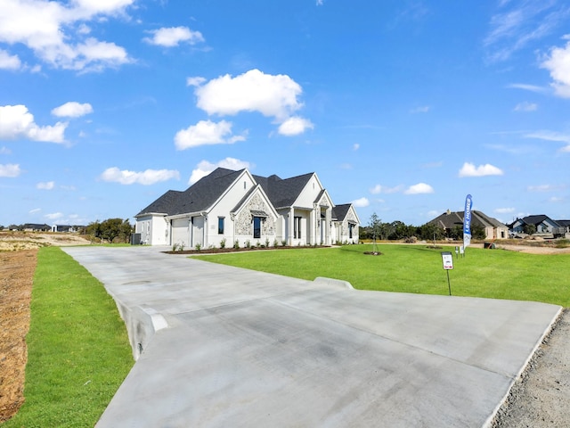 view of front of home with a garage and a front yard