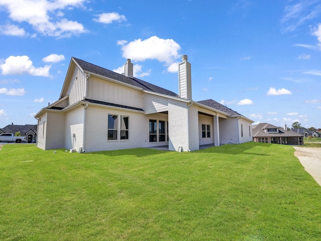 back of house with a yard