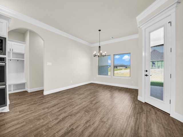 unfurnished dining area with dark hardwood / wood-style floors, crown molding, and a notable chandelier