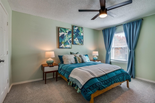 carpeted bedroom featuring a textured ceiling and ceiling fan