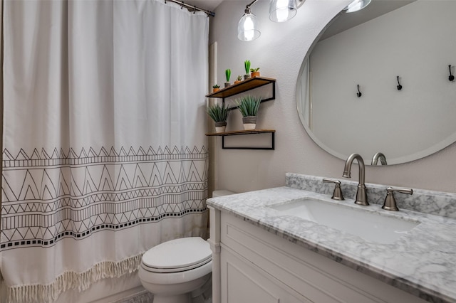 bathroom with vanity, toilet, and walk in shower