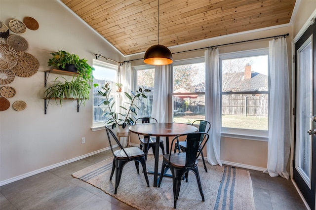 tiled dining area featuring lofted ceiling and wooden ceiling