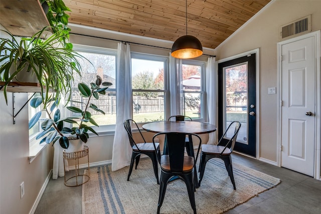 dining room with wood ceiling, plenty of natural light, and vaulted ceiling