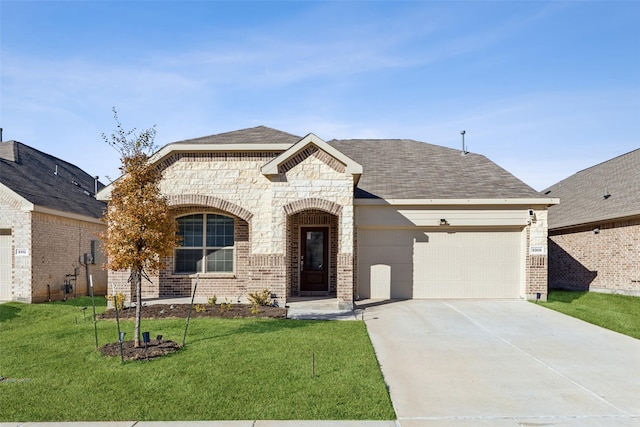 view of front facade with a garage and a front lawn