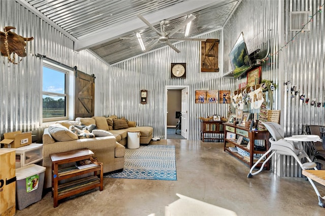 living room featuring a barn door, concrete floors, and ceiling fan