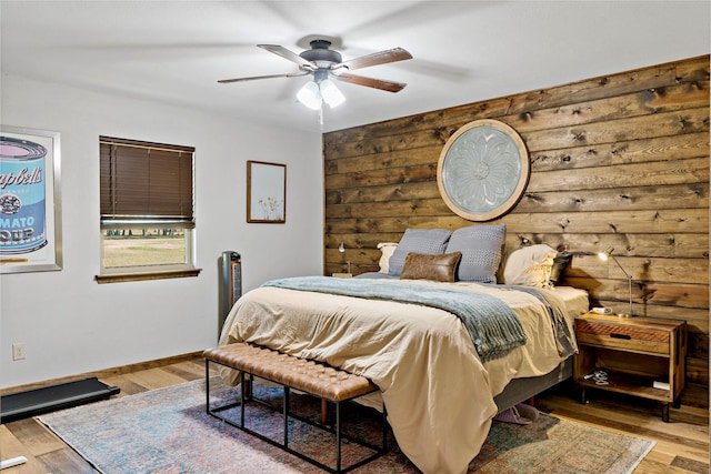 bedroom with ceiling fan and wood-type flooring