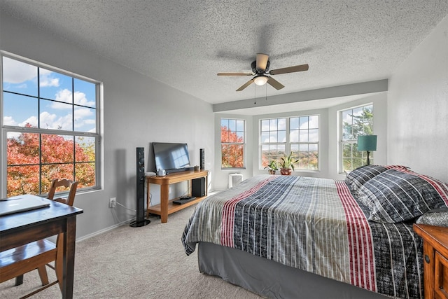 bedroom with ceiling fan, carpet, and a textured ceiling