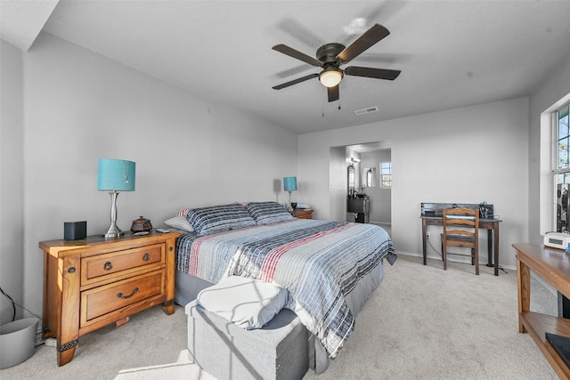 bedroom with ceiling fan and light carpet