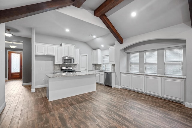 kitchen featuring appliances with stainless steel finishes, dark hardwood / wood-style flooring, white cabinetry, and light stone counters