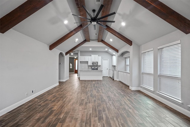 unfurnished living room featuring vaulted ceiling with beams, ceiling fan, and dark hardwood / wood-style flooring