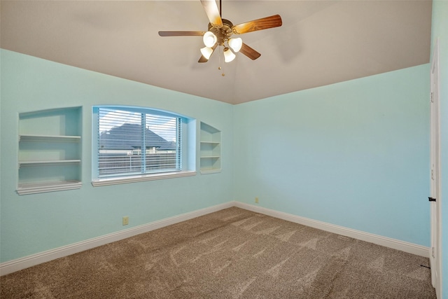 unfurnished room featuring ceiling fan, built in features, and carpet floors