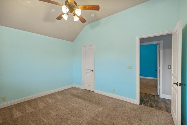 unfurnished room with ceiling fan, dark hardwood / wood-style floors, and vaulted ceiling