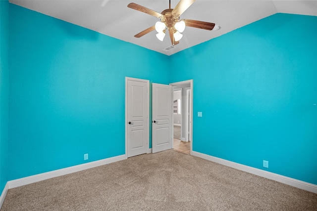 unfurnished room featuring ceiling fan, light colored carpet, and lofted ceiling