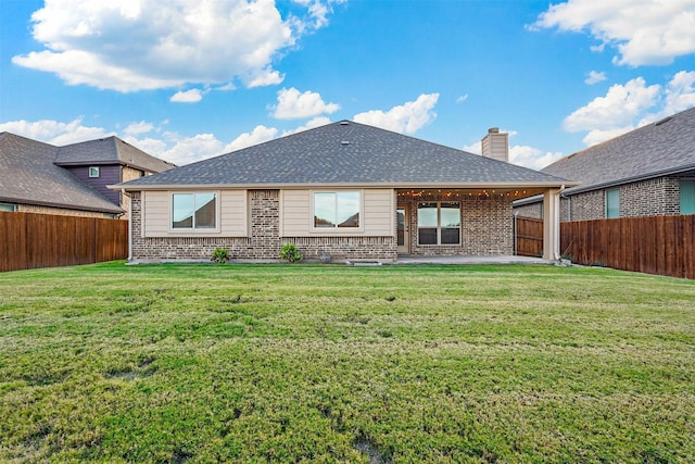 back of house featuring a yard and a patio