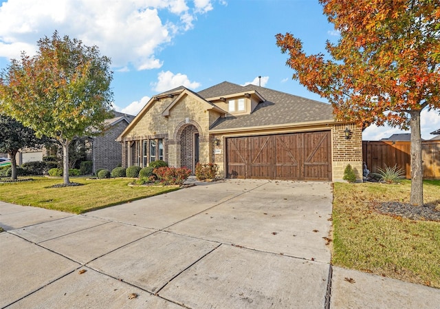 view of front of home with a front lawn and a garage