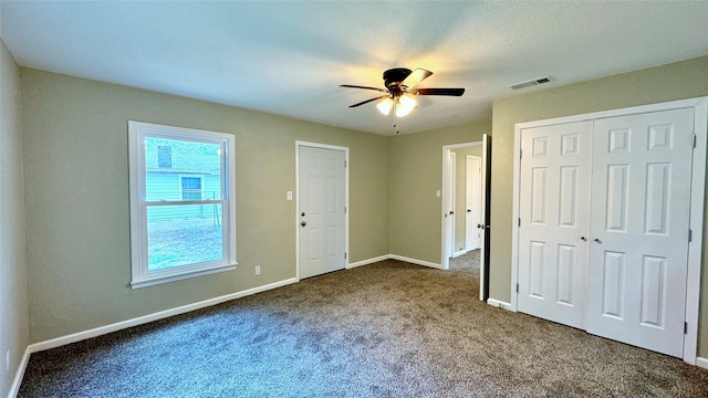 unfurnished bedroom with carpet and ceiling fan