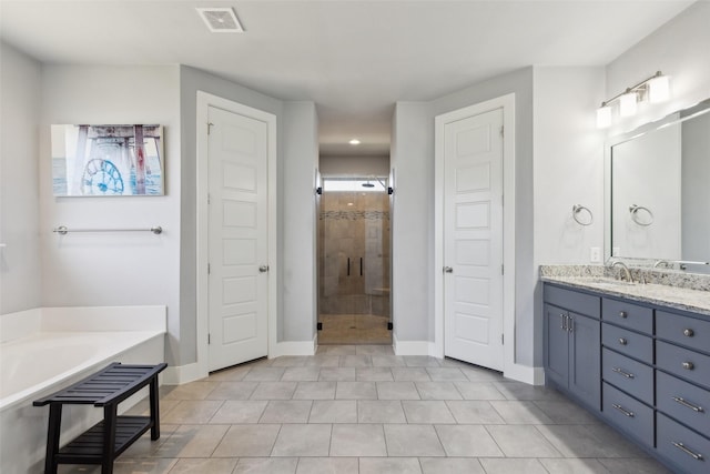 bathroom with plus walk in shower, vanity, and tile patterned flooring