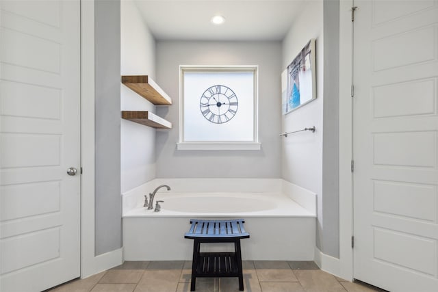 bathroom featuring a tub to relax in and tile patterned floors